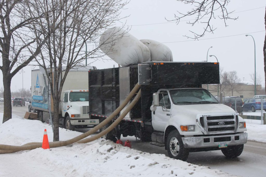 Evacuation truck vacuuming out existing insulation