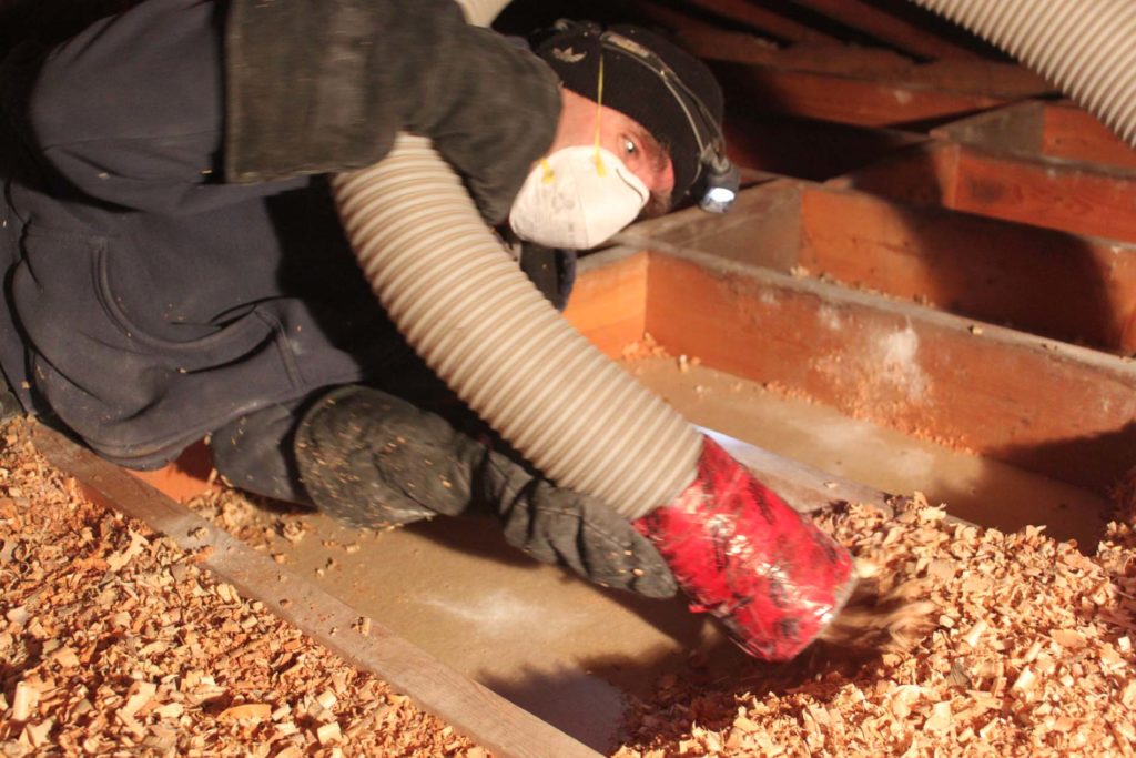 Wood Shavings being removed in preparation for 2" polyurethane spray foam vapour seal