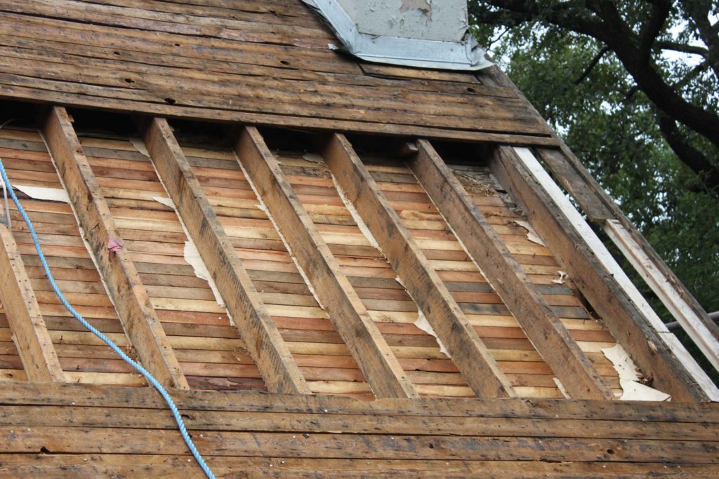 Cathedral ceiling rafters emptied of existing wood shavings for 4" polyurethane spray foam treatment