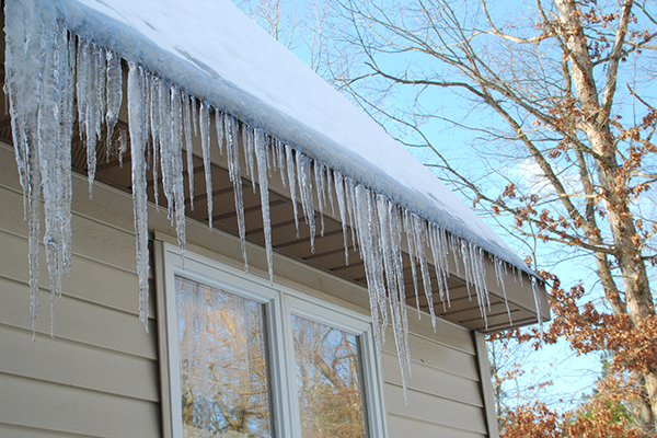 Icicles hanging from a snow-covered roof.