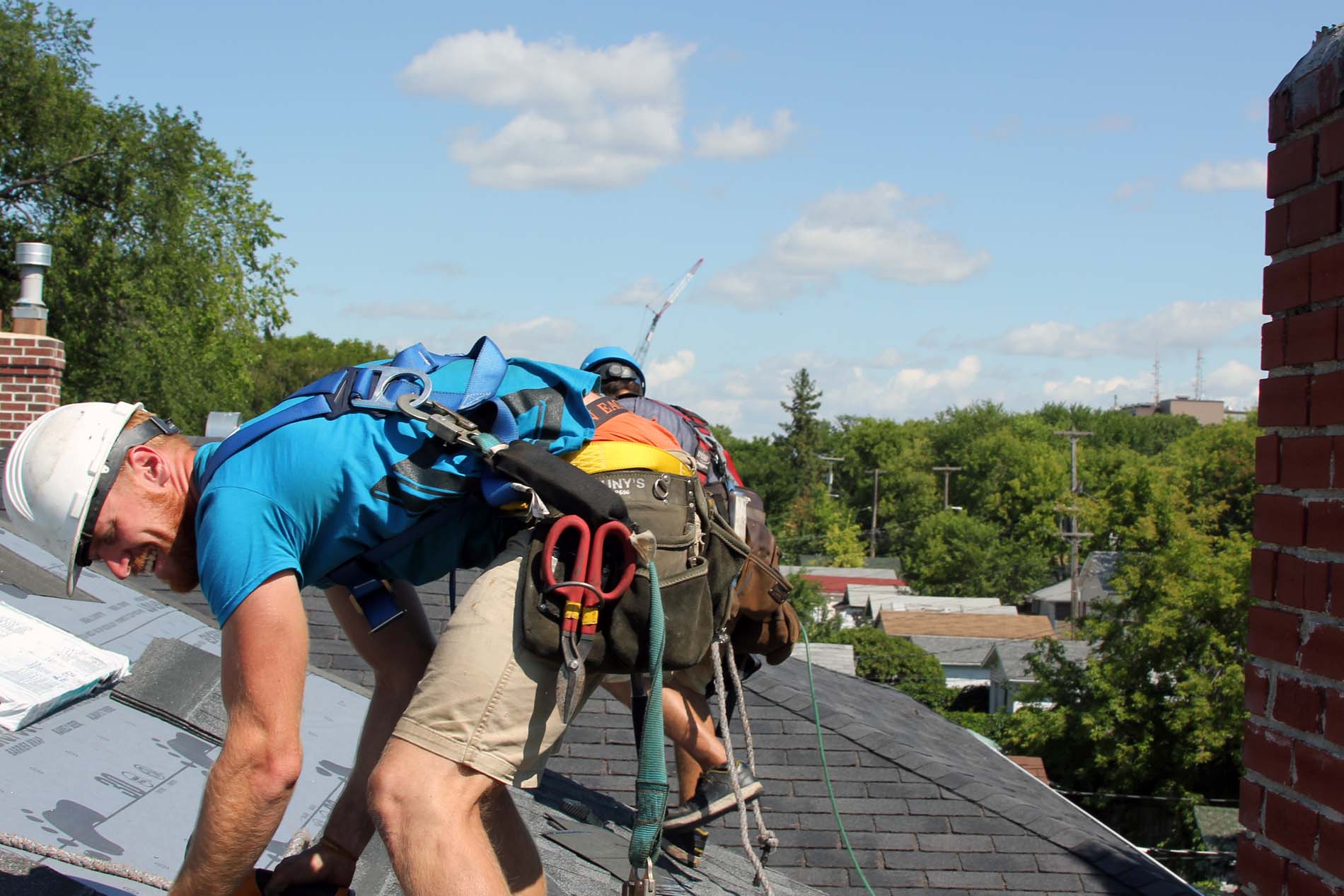 Happy Winnipeg roof installers on roof roofing