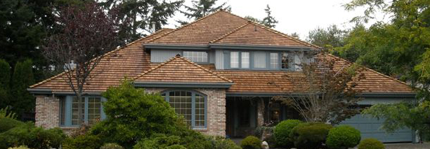 A large home with a cedar shake roof.