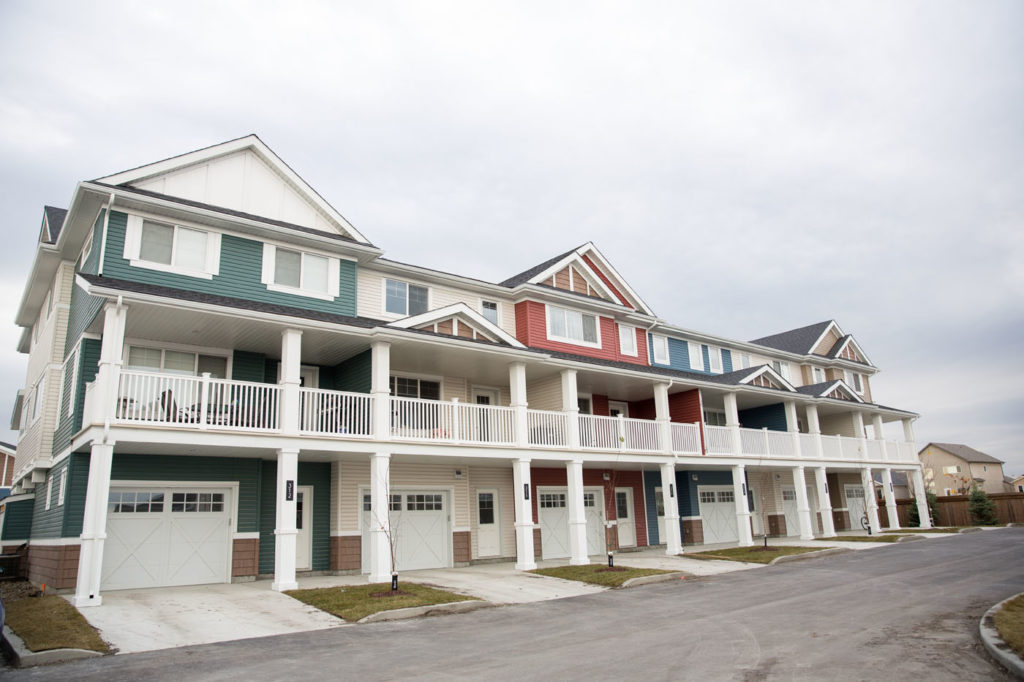 Winnipeg multi-family development with colourful varying siding colours.