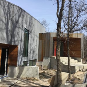 Metal, concrete, and wood siding provide an inspiring exterior to this Winnipeg home